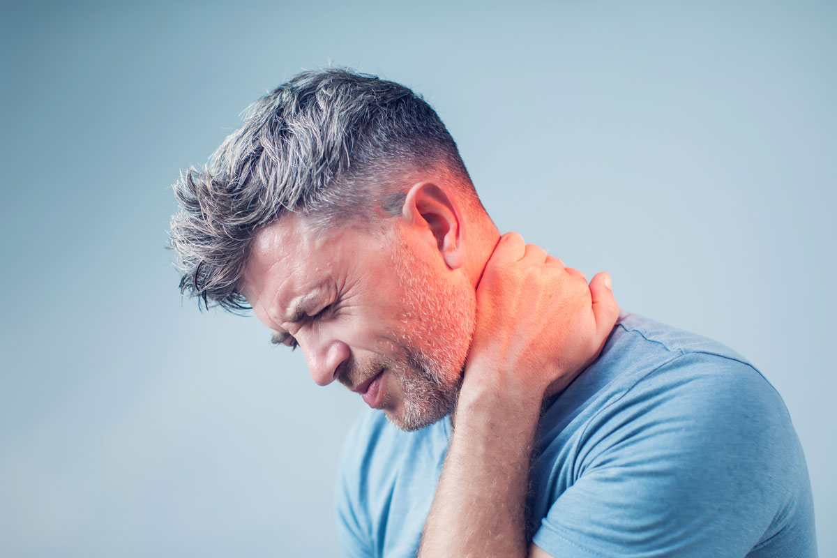 Man holding his neck in pain.